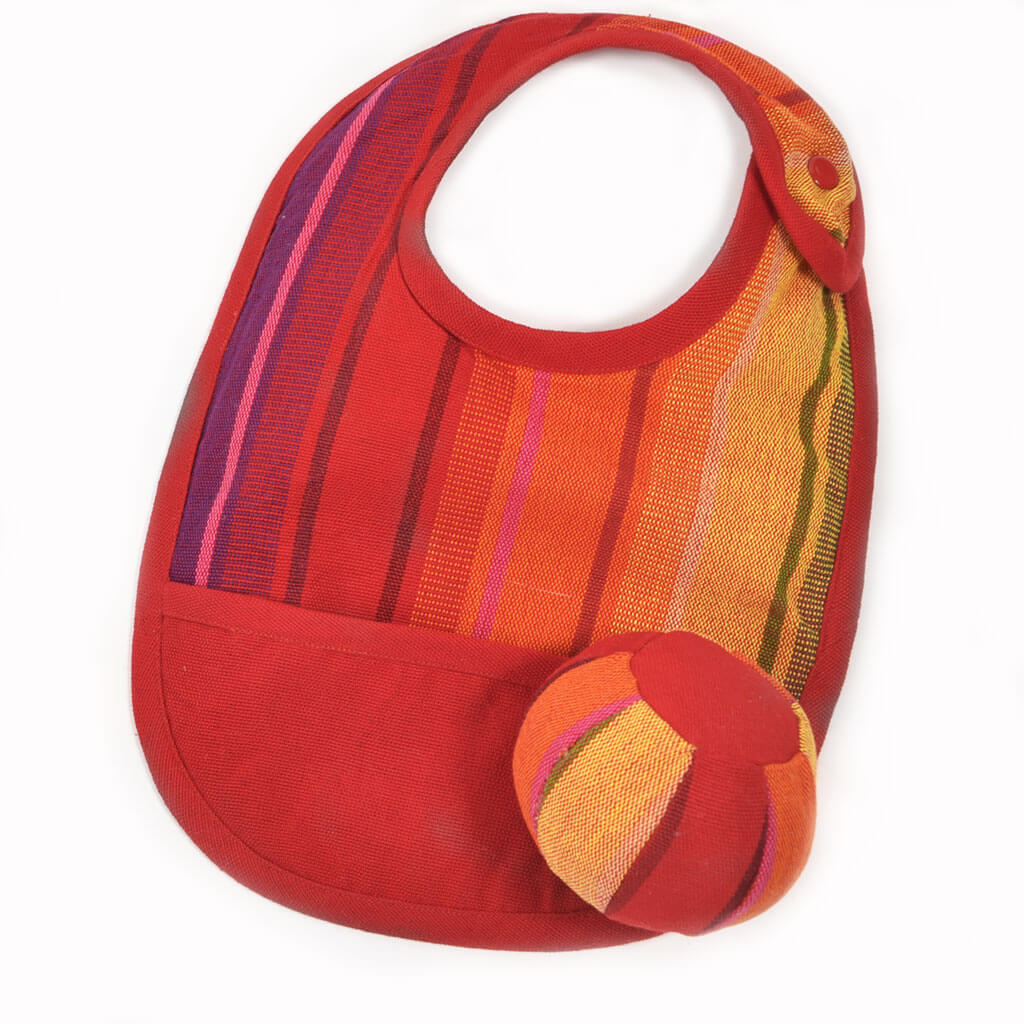 Shades of red baby bib and ball. 