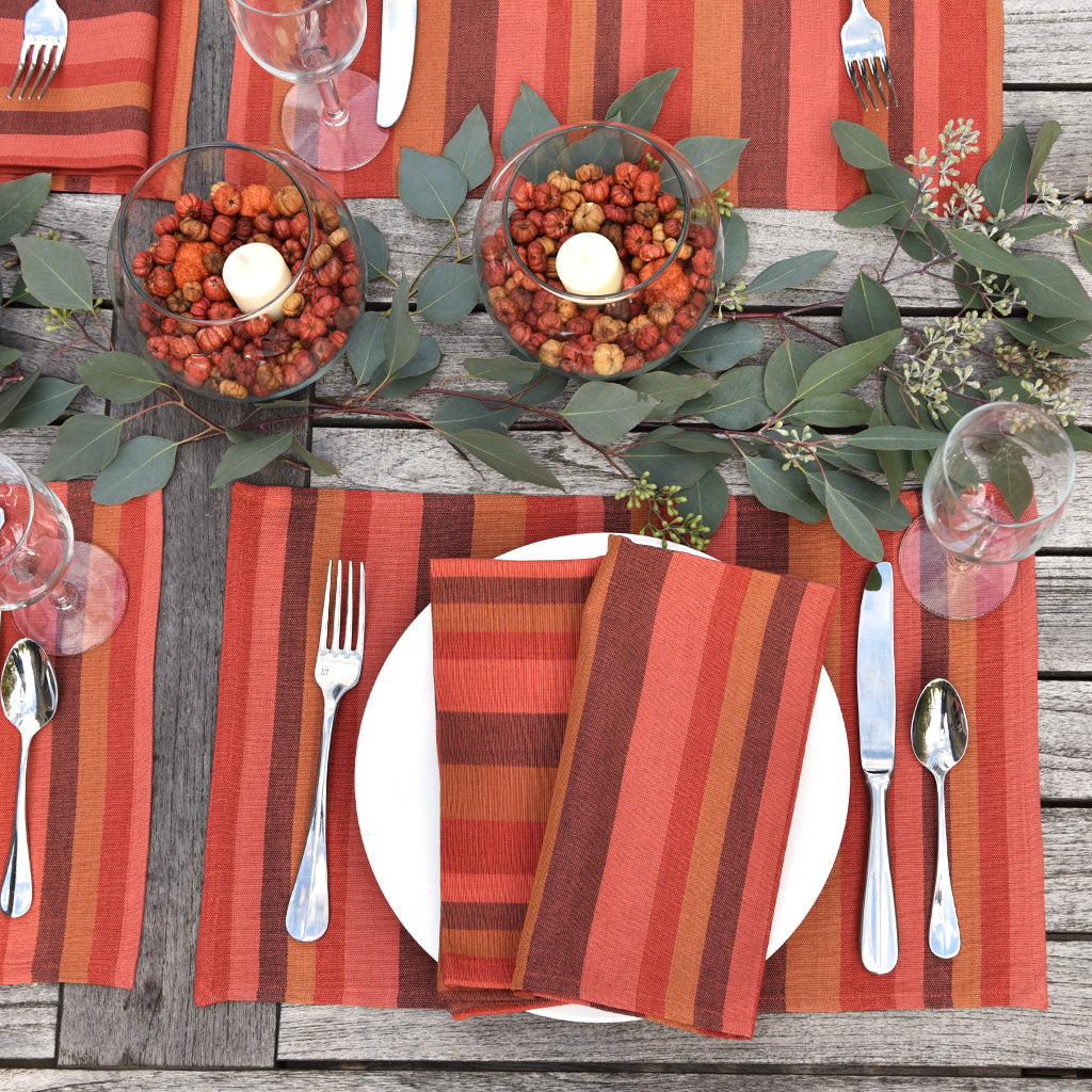 Pumpkin stripe placemats and napkins in a table setting