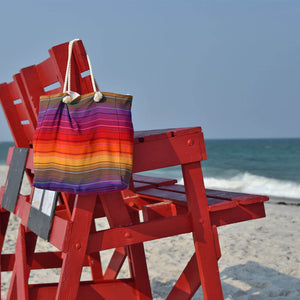 Waterproof Beach Tote with bright rainbow stripes.